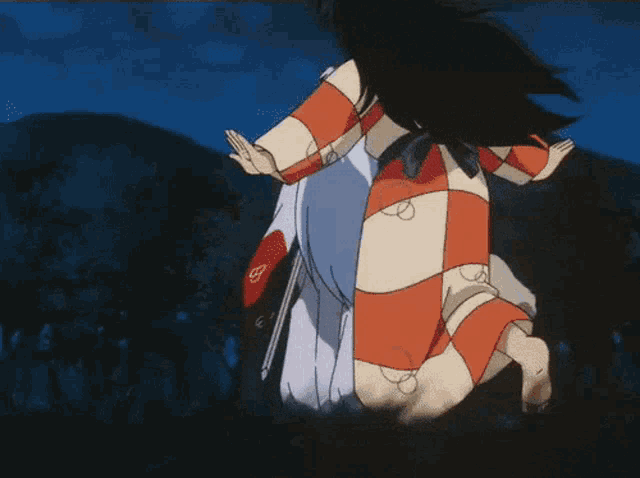a woman in a red and white striped dress is kneeling down in the dark