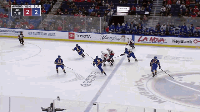 a hockey game is being played in a stadium sponsored by keybank and toyota