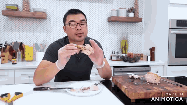 a man is eating a piece of meat in a kitchen with the words made in animatica on the bottom