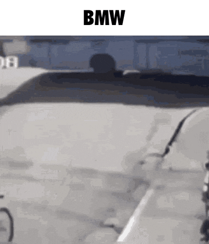 a man is driving a bmw with a broken windshield and a broken windshield wiper .