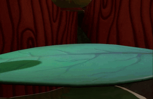 a cartoon character with a yellow flower on its head is sitting on a table