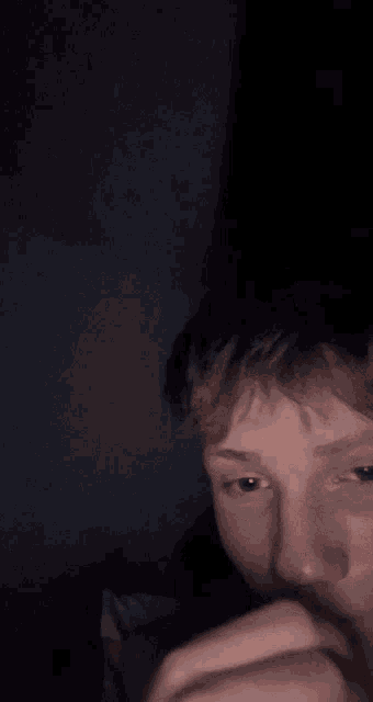 a blurry picture of a person 's face with their hands on it