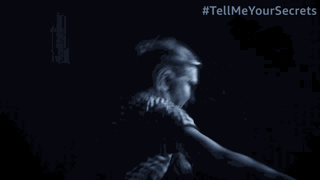 a blurred image of a person behind blinds with the hashtag tell me you love me