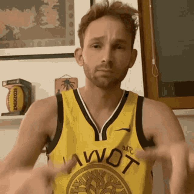 a man is wearing a yellow jersey that says iwot on it