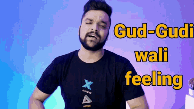 a man with a beard wearing a black t-shirt that says gud-gudi wali feeling