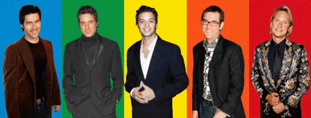 a group of men standing next to each other in front of a colorful background
