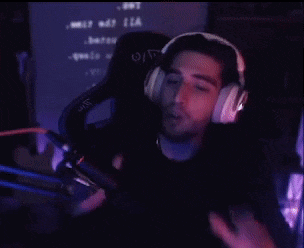 a man wearing headphones is sitting in a chair and making a peace sign