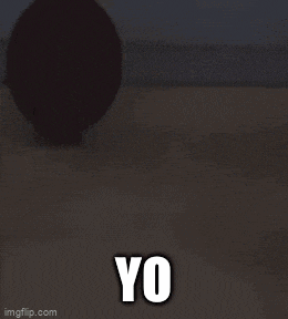 a boy in a blue shirt is standing in a gym with the word yo in white letters