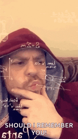 a man in a red hoodie is holding his hand to his chin while looking at a math problem on his face .