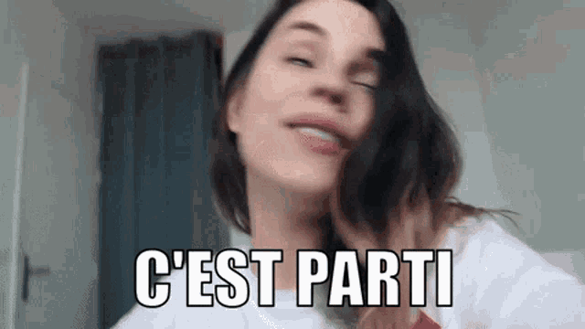 a close up of a woman 's face with the words `` c'est parti '' written on the bottom .