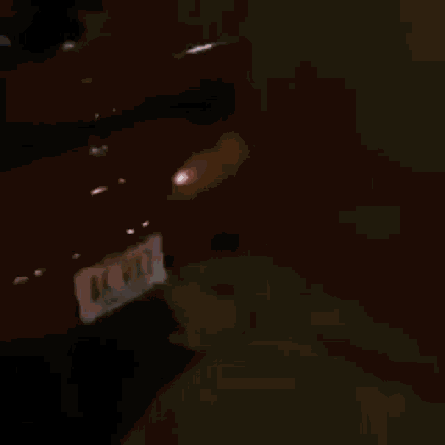 a red car is driving down a road with a lot of white smoke coming out of it