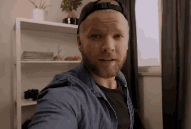 a man with a beard is taking a selfie