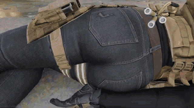 a woman laying on the ground with a tactical belt around her waist and a pair of scissors in her pocket
