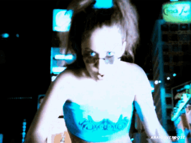 a woman in a blue top with the word freedom painted on it