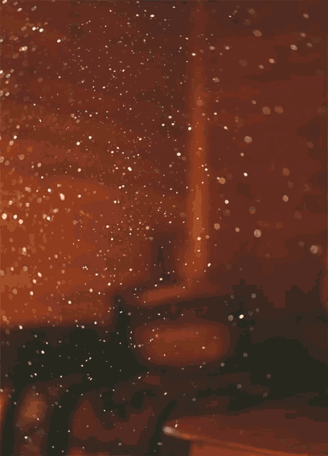 a blurred image of a room with a few lights on the wall