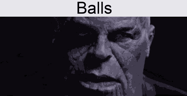 a close up of a man 's face with the words `` balls '' written on it .