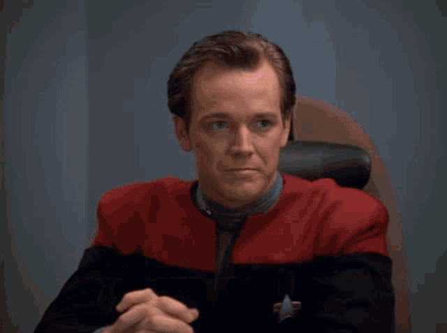 a man sitting in a chair with the words am i making any sense here behind him