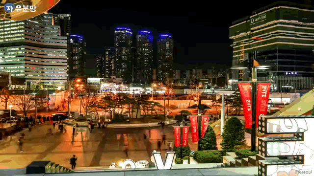 a city at night with a sign that says ' new v ' on it