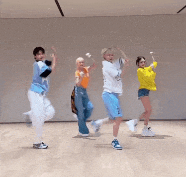 a group of people are dancing in a room and one of them has the number 2 on their shirt