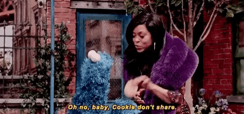 a woman in a purple fur coat is standing in front of a blue door holding a stuffed animal .