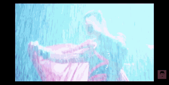 a man holding a red flag in the rain with a red r on the bottom right corner