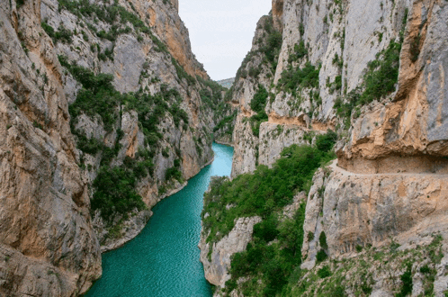 a river runs through a narrow canyon between two rocky cliffs