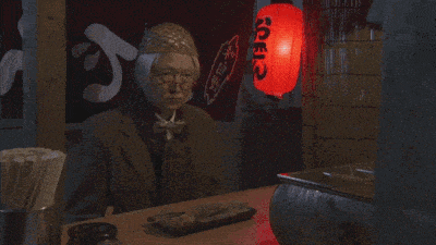 a man smoking a cigarette in front of a red lantern that says ' shoji ' on it