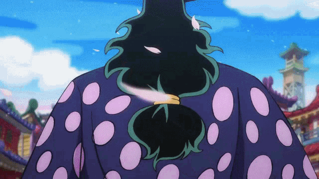 a close up of a person 's back with polka dots and a ponytail