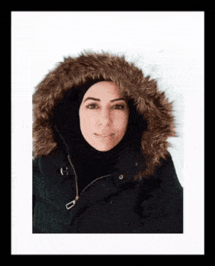 a woman wearing a black jacket with a brown fur hood