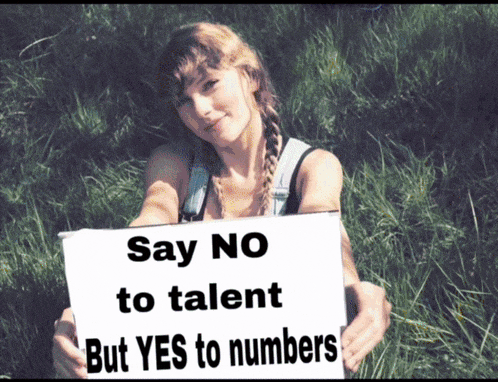a woman holds up a sign that says " say no to talent but yes to numbers "