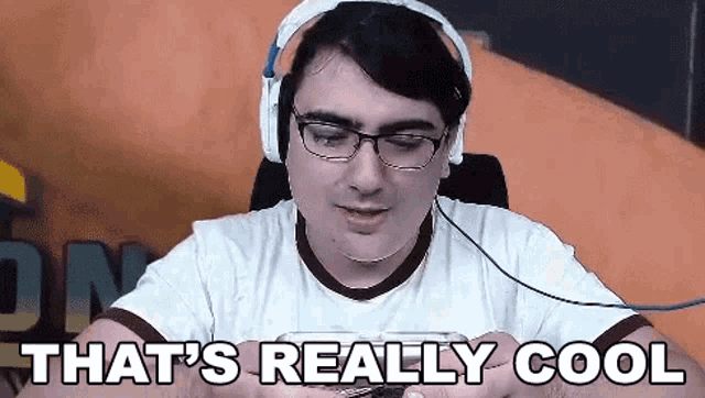 a man wearing headphones and glasses is sitting in a chair .
