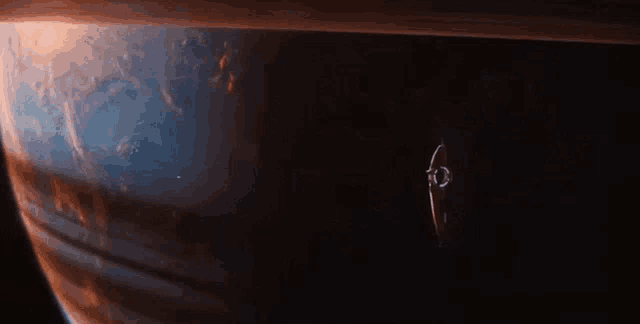 a space ship is flying in front of a planet in space