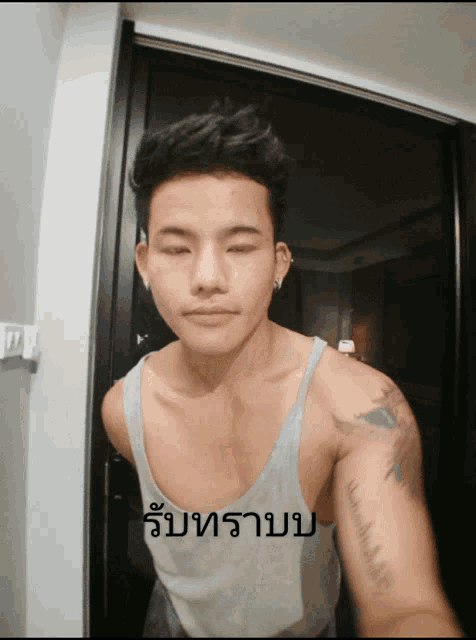 a man with a tattoo on his arm is taking a picture