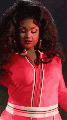 a woman in a pink jacket with a white stripe on the waist