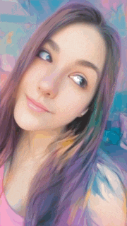 a girl with purple hair is smiling for the camera