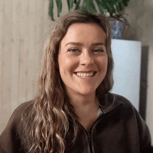 a woman with a nose ring smiles for the camera