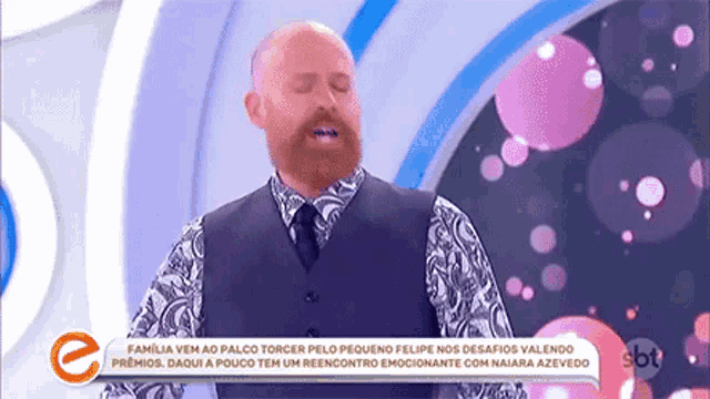 a man with a beard is standing in front of a sign that says sbt