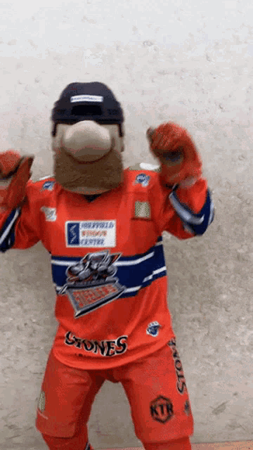 a mascot is wearing an orange jersey with the word stones on it