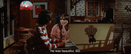 a man and a woman are sitting at a table with the man saying he was beautiful too