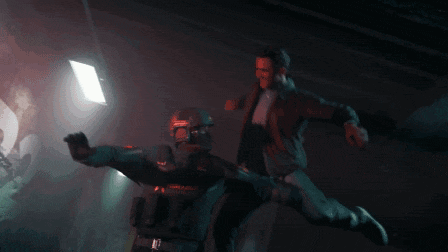 two men are fighting in a dark room and one has the number 47 on his back