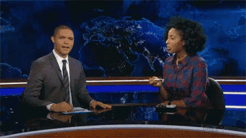 a man in a suit and tie is talking to a woman