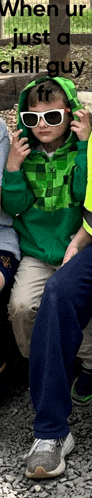 a young boy wearing sunglasses and a green jacket with the words when ur just a chill guy written above him