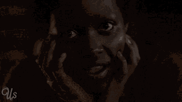 a close up of a person 's face with the words us below
