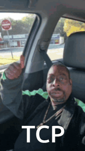 a man in a car is giving a thumbs up and the word tcp is on the bottom