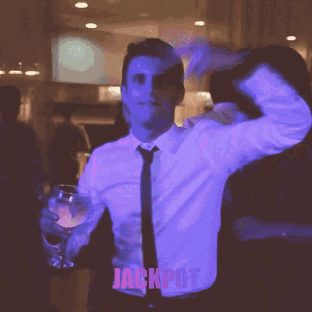 a man in a white shirt and tie is holding a glass of wine and the word jackpot is behind him