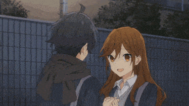 a boy and a girl are kissing in a close up of their faces .
