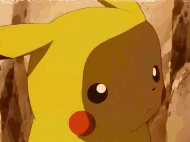 a close up of a pikachu looking at the camera with a serious look on its face .