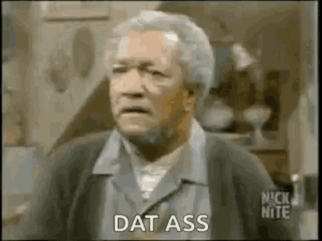 an older man with gray hair and glasses is standing in a room and says `` dat ass '' .