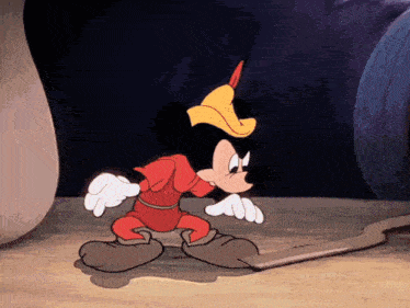 a cartoon of mickey mouse wearing a red and yellow outfit