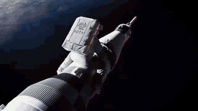 a man in a space suit with the word iota on the back